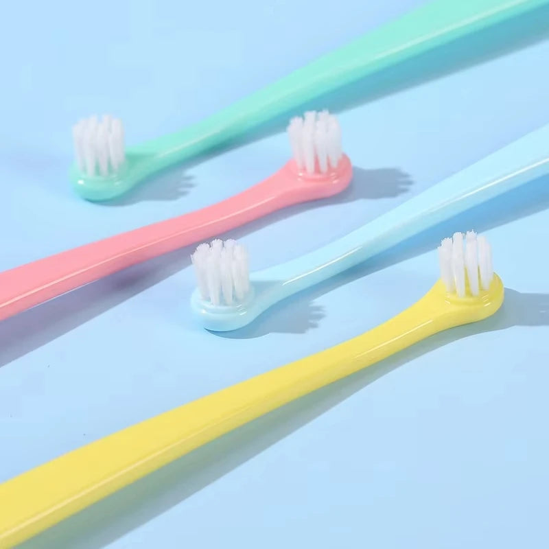 KittyNook Cat Co.'s Kitty Clean Micro Head Dental Brushes in pink, blue, and yellow on a light blue background.