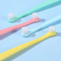 Thumbnail for KittyNook Cat Co.'s Kitty Clean Micro Head Dental Brushes in pink, blue, and yellow on a light blue background.