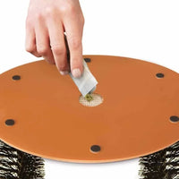 Thumbnail for Hand places tea bag in mesh of 3-in-1 Cat Self-Grooming Arch Toy by KittyNook Cat Co. for fur removal and grooming.