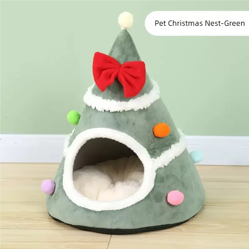 The Christmas Tree Cat Mat by KittyNook Cat Co. is a green cat bed with ornaments, a red bow, and a pom-pom on top.