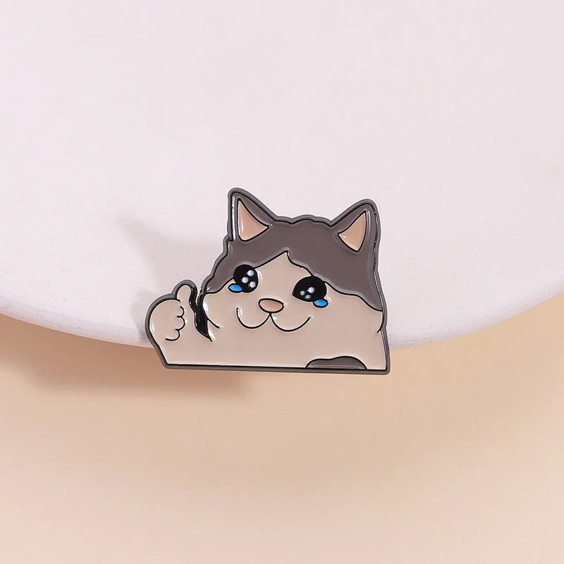 KittyNook Cat Co.'s Kawaii Thumbs Up Crying Cat Enamel Pin—cute accessory, blue eyes, happy vibe on pink!.