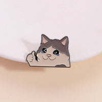 Thumbnail for KittyNook Cat Co.'s Kawaii Thumbs Up Crying Cat Enamel Pin—cute accessory, blue eyes, happy vibe on pink!.
