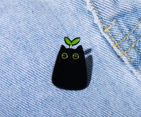Thumbnail for KittyNook Cat Co.'s Black Cat Enamel Brooch with green eyes and a sprout is perfect for enamel jewelry lovers.