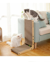 Thumbnail for Two cats play by KittyNook Cat Co.’s Durable L-Shape Cardboard Cat Scratching Post, doubling as a sofa protector.