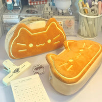 Thumbnail for Two cute pencil cases, including KittyNook Cat Co.'s Caramel Cat Plush Pencil Case, sit on a desk with a 31-day planner.