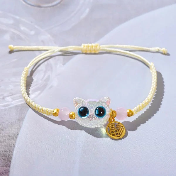 The Lucky Charm Bracelet for Good Fortune by KittyNook Cat Co. features gold, pink beads, and a cat face charm.