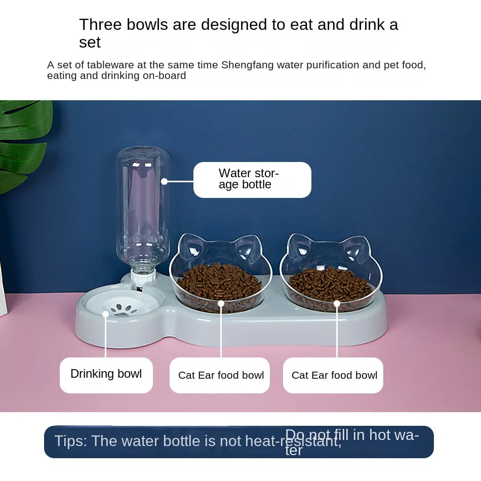 KittyNook Cat Co. Automatic Water Renewal Cat Bowl with food bowls on a pink and white surface.