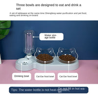 Thumbnail for KittyNook Cat Co. Automatic Water Renewal Cat Bowl with food bowls on a pink and white surface.