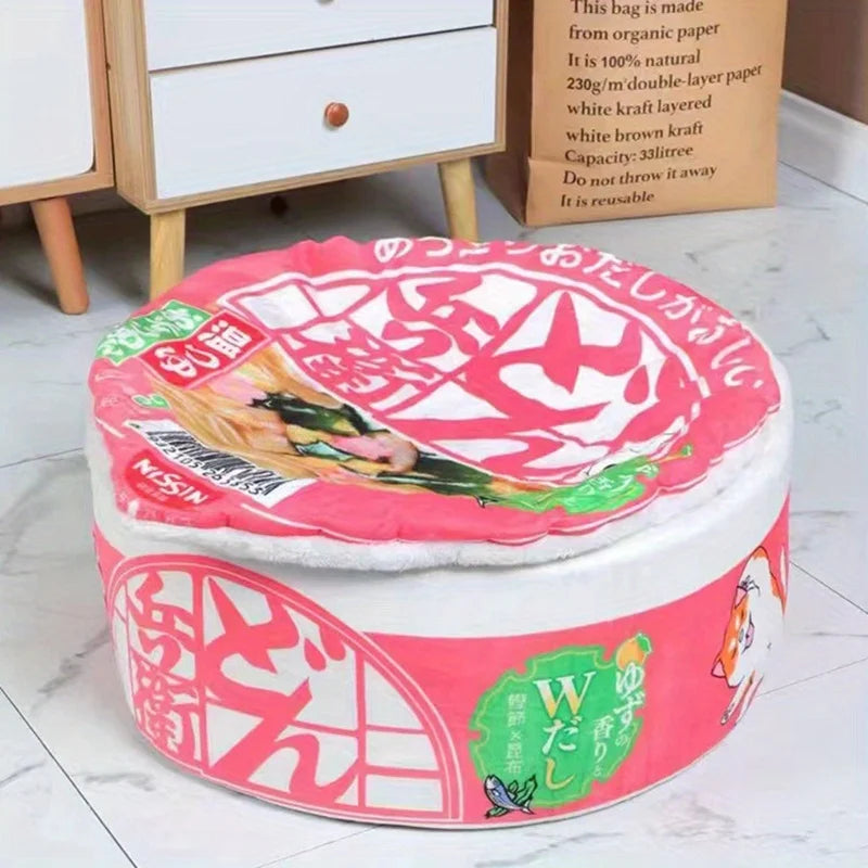 The Instant Noodles Cat Bed by KittyNook Cat Co. mimics noodle packaging with Japanese text and a cozy, removable cover.