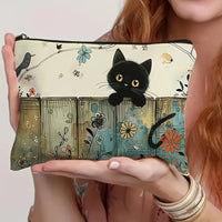 Thumbnail for A woman holds the KittyNook Cat Co. Vintage Floral Kitty Makeup Pouch with a black cat amid colorful blooms.