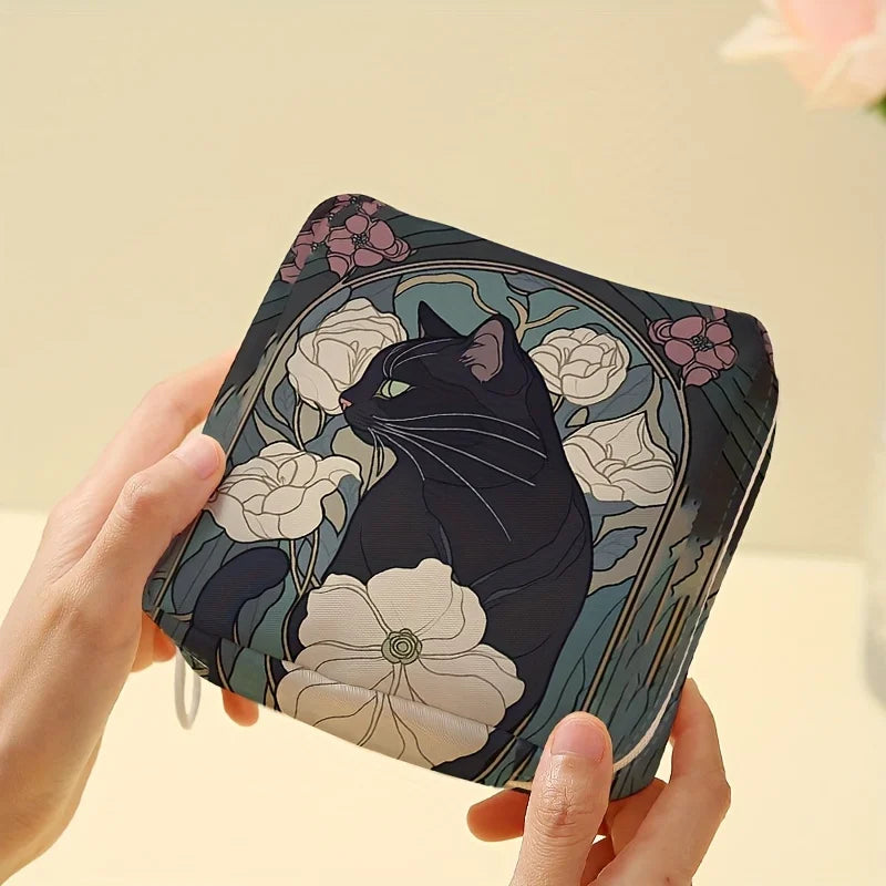 Hands hold the KittyNook Cat Co. Cat Pattern Printed Sanitary Napkin Storage Bag with black cats and white flowers.