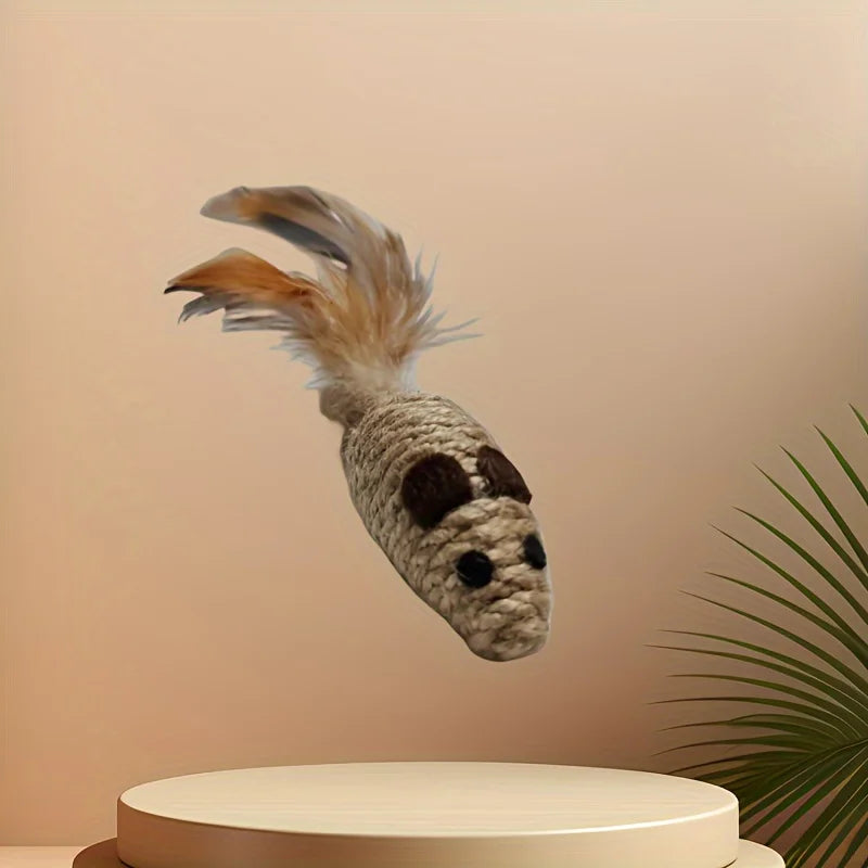 KittyNook Cat Co.’s Sisal Fake Mouse Cat Toy has a feather-tailed mouse floating above a round beige platform with a plant.