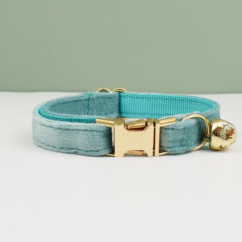KittyNook Cat Co. Velvet Cat Collar in light blue with gold buckle and bell, soft to touch, shown on white with green backdrop.