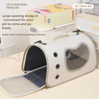 Thumbnail for KittyNook Cat Co. Premium Foldable Small Cat Carrying Bag with mesh windows, shown in a cozy room with toys nearby.
