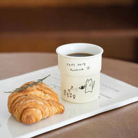 Thumbnail for A croissant and coffee in a KittyNook Cat Co. Cute Illustrated Ceramic Cat Mug on a white tray.