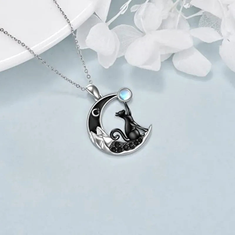 KittyNook Cat Co. Cute Black Kitty Moon Necklace—perfect cat lover gift with a blue gem on a silver crescent moon.