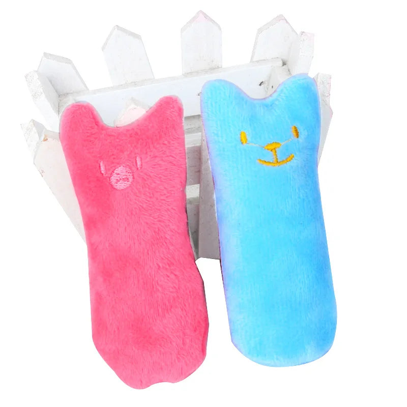 Two KittyNook Cat Co. Safe Catnip Chew Toys rest on a white crate, perfect for relieving cat boredom.
