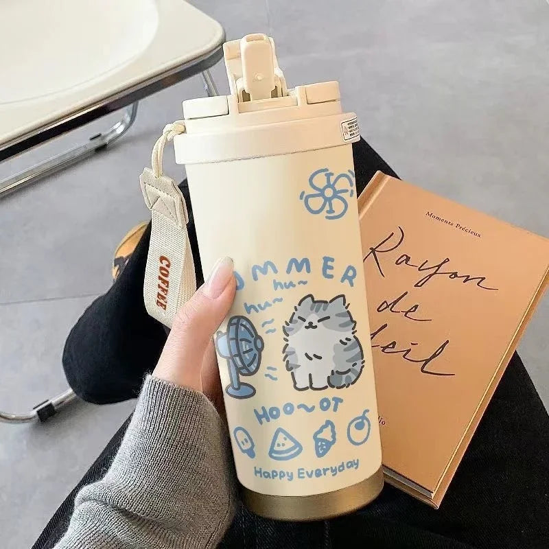 Someone holds a KittyNook Cartoon Kitty Stainless Steel Travel Cup with summer icons, reading "Rayon de Soleil.