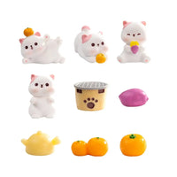 Thumbnail for Nine small toys, like KittyNook Cat Co. Creative Cat Doll Car Ornament, a grill, teapot, and fruits on white background.