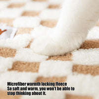 Thumbnail for A white cat’s paw rests on fleece, cozy beside the KittyNook Cat Co. Winter Warm Plush Tunnel Cat Bed.