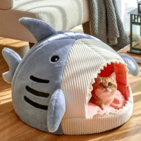 Thumbnail for A cat peeks out from the mouth of the KittyNook Cat Co. Shark-Shaped Cat Cave Bed.
