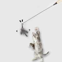Thumbnail for A gray tabby cat jumps for the KittyNook Cat Co. Eco-Friendly Wood & Feather Cat Teaser against a white background.