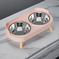 Thumbnail for The KittyNook Dopamine DuoLift Cat Feeder in pink with 2 stainless steel bowls on a marble countertop.