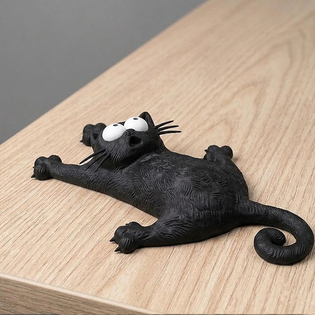 KittyNook Cat Co.’s Hanging Kitty Magnetic Fridge Decor features a surprised cartoon black cat on a light wooden surface.
