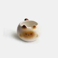 Thumbnail for KittyNook Cat Co. Siamese Cat Coffee Cup features a cat face, ears, and tail in light brown and cream—perfect for cat lovers.