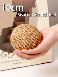 Thumbnail for Hand holding KittyNook Cat Co. Premium Sisal Kitten Scratching Ball—10cm eco-friendly cat toy on beige background.