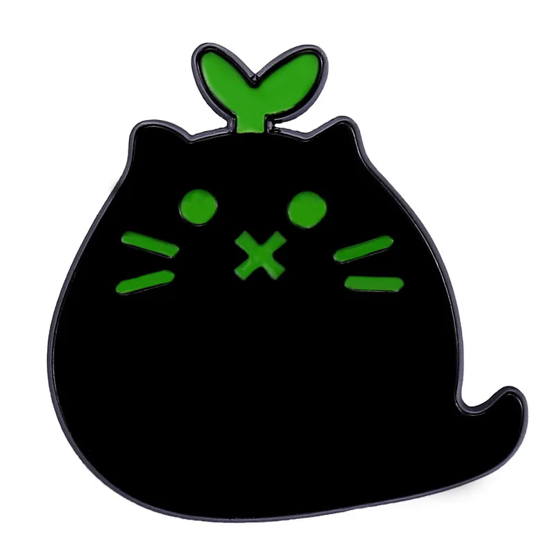 The Black Cat Enamel Brooch by KittyNook Cat Co. is a cute green-eyed pin—purrfect for any cat lover!.