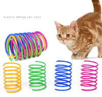 Thumbnail for A brown cat plays with KittyNook Cat Co. Colorful Spiral Spring Cat Toy Pack in yellow, green, blue, and pink.