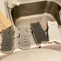 Thumbnail for KittyNook Cat Co.’s Adorable Cat-Shaped Dish Sponge Set – 4 pieces, in gray and white, sits by the kitchen sink.