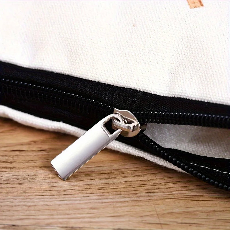 Close-up of the silver zipper on a Vintage Floral Kitty Makeup Pouch by KittyNook Cat Co., resting on wood.