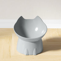 Thumbnail for KittyNook Cat Co. Orthopedic Raised Cat Feeder, gray with ears and paws, on a light wood floor by a white wall.