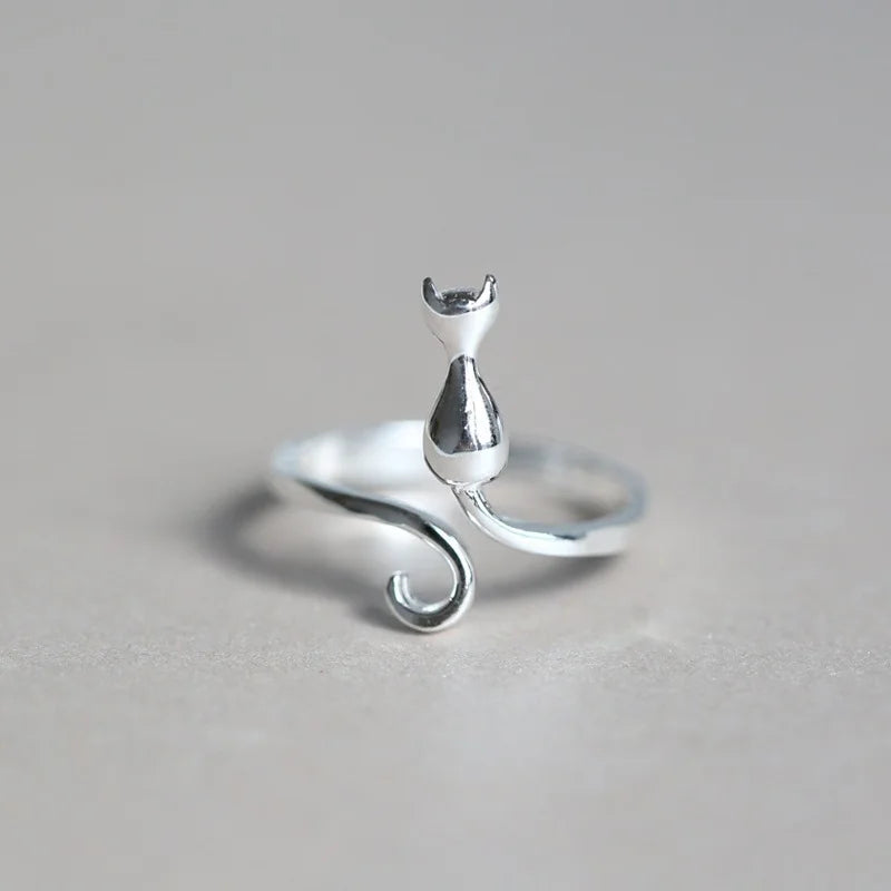 The Cute Adjustable Silver Cat Ring by KittyNook Cat Co. features a minimal feline design with curled tail and pointed ears.