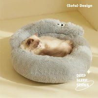 Thumbnail for A fluffy cat naps in the Warm & Soft Cat Sleeping Pod by KittyNook Cat Co., basking in sunlight.