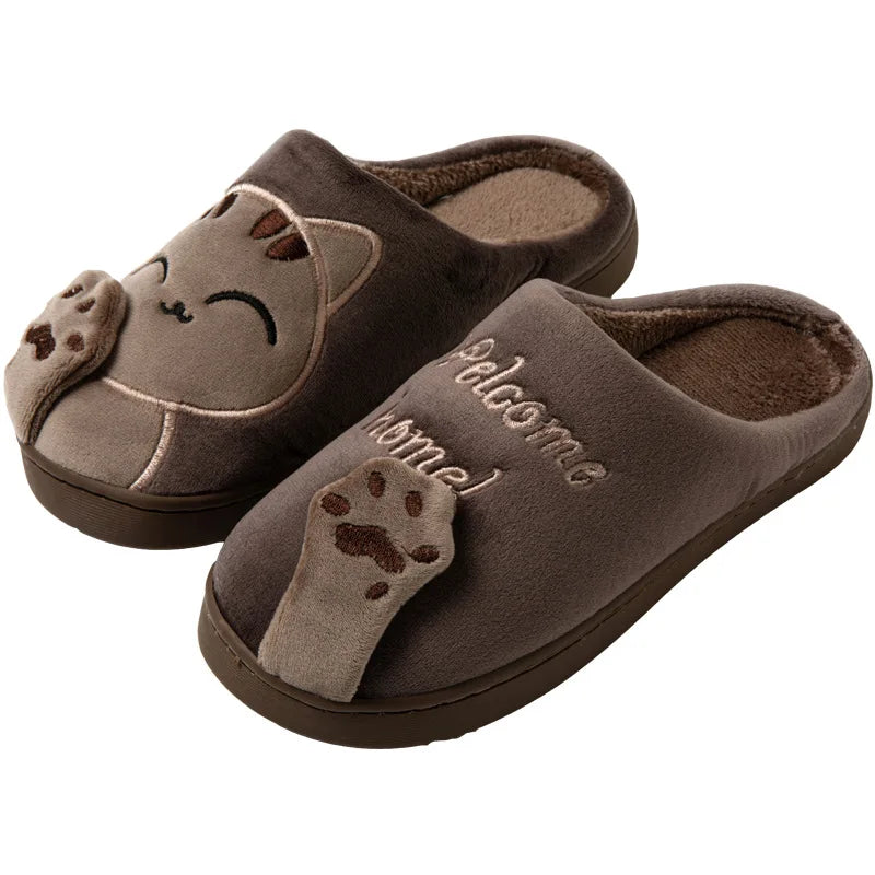 KittyNook Cat Co. Happy Pawprints Lucky Cat Slippers feature a cute cat face, ears, paws, and "Welcome home!" embroidery.