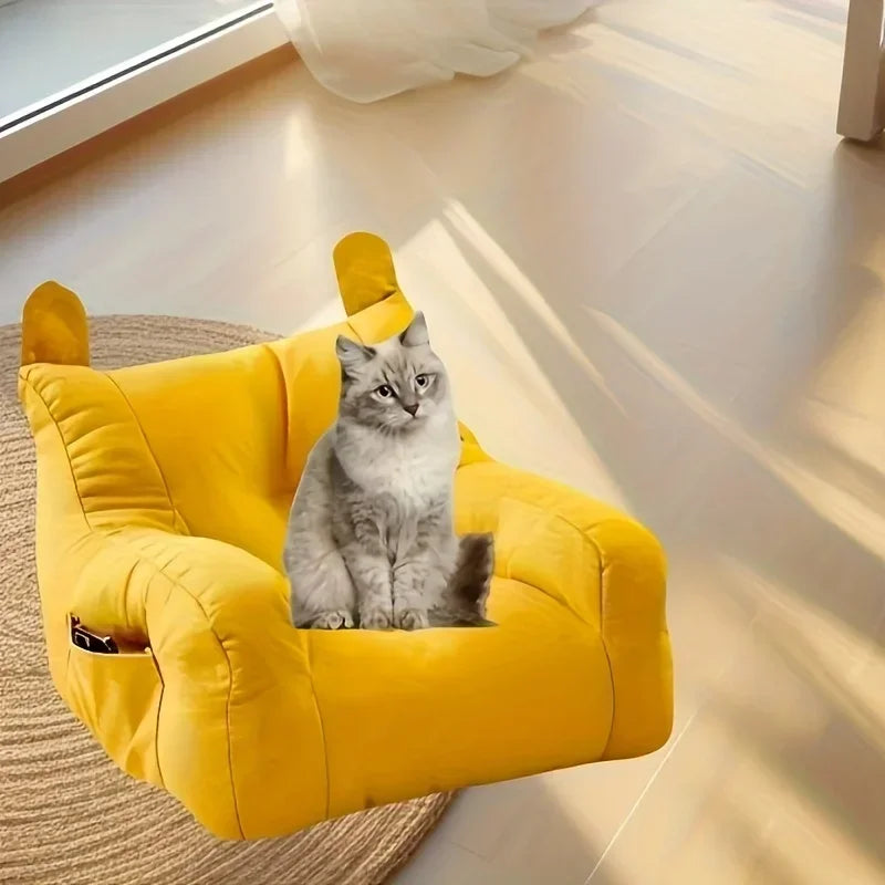 A fluffy gray cat lounges on a KittyNook Cat Co. Cat Cartoon Sofa Bed, adding charm to the sunlit room.