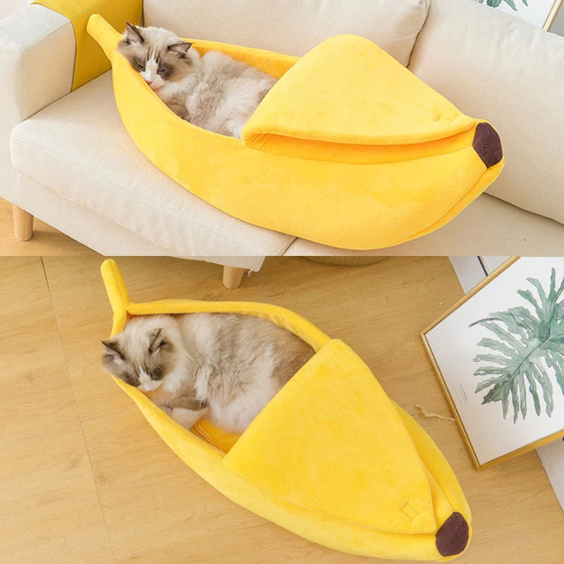 A fluffy cat sleeps in a Cute Funny Banana Shape Cat Bed by KittyNook Cat Co. on the floor and couch.
