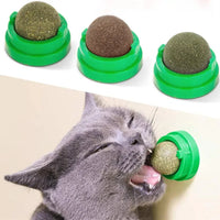 Thumbnail for KittyNook Cat Co. Stick-On Natural Catnip Ball for Cats, with gray cat licking one mounted on the wall.