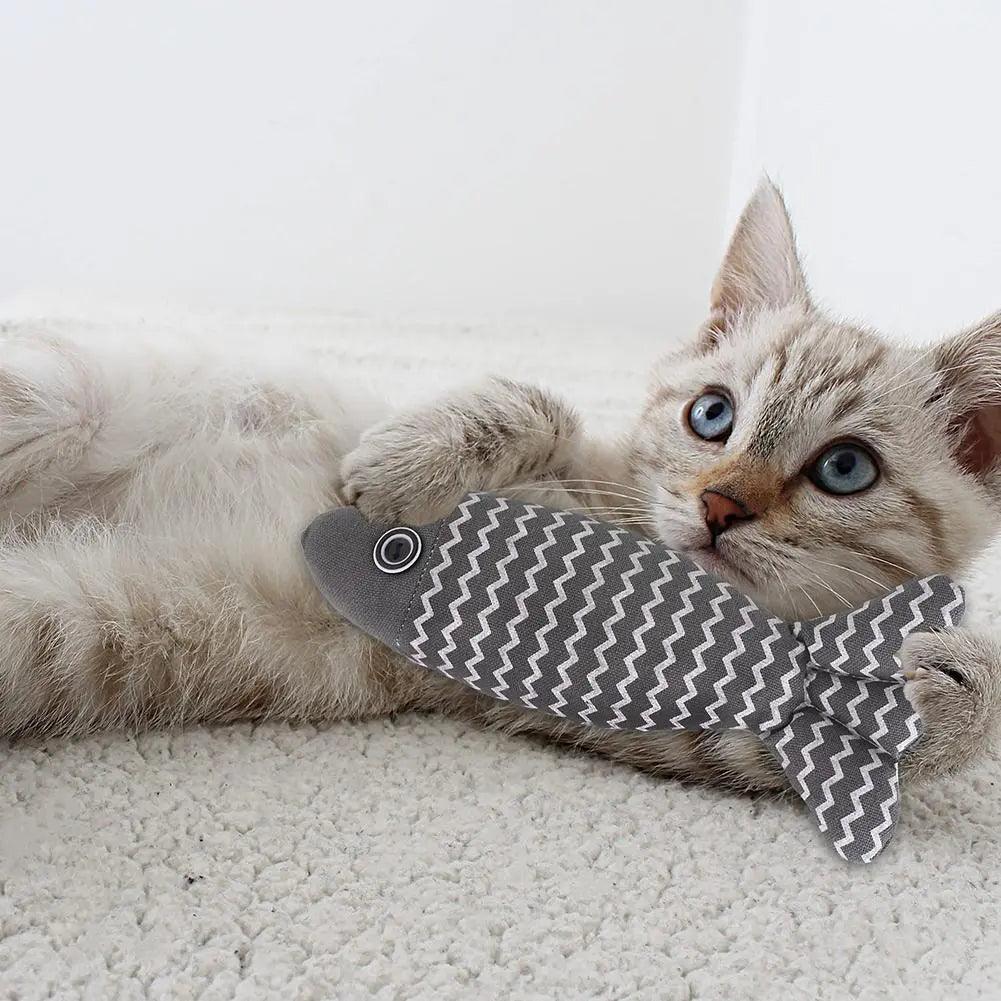 a cat playing with Linen Catch Fish Toy in grey