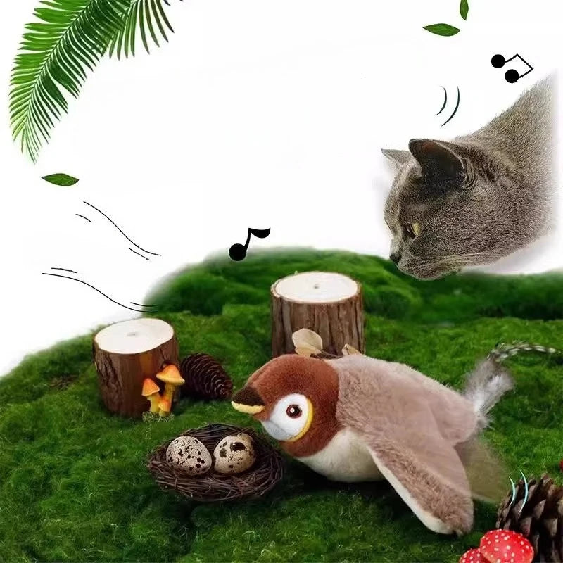 A gray cat enjoys mental stimulation, watching a KittyNook Cat Co. Squeaky Plush Cat Toy bird and nest on moss.