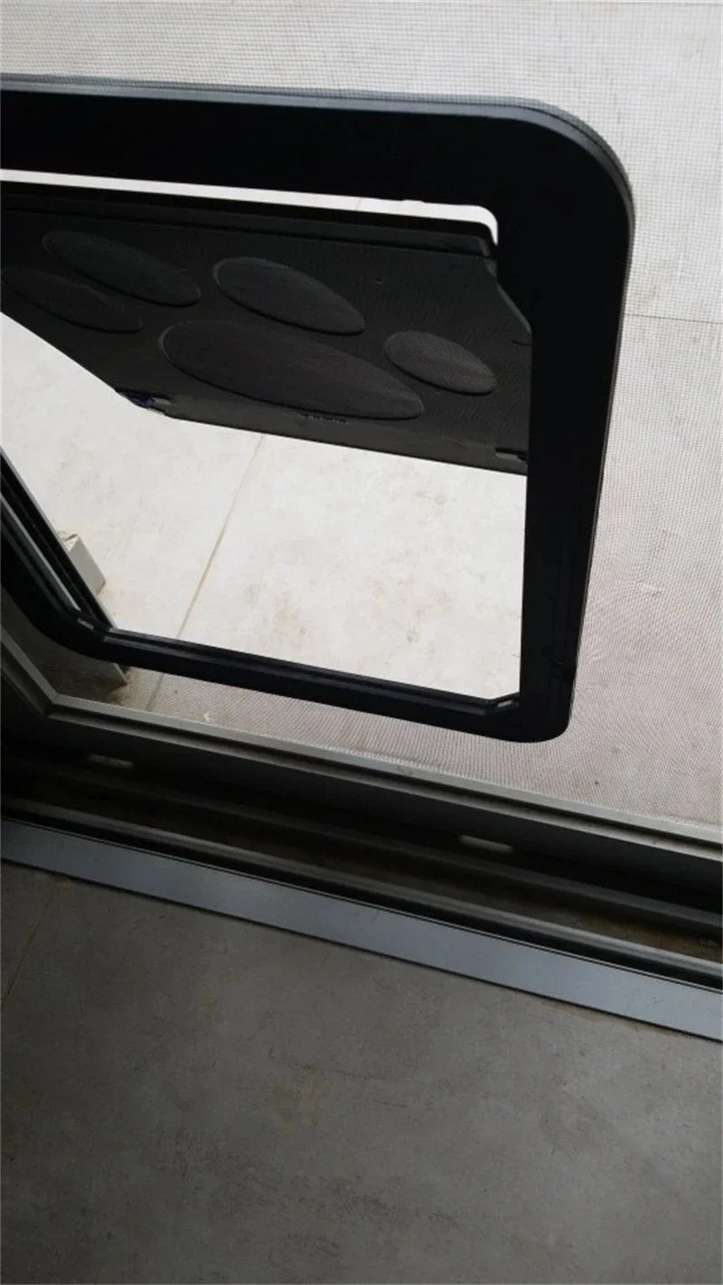 A KittyNook Magnetic Lockable Pet Screen Door is installed in a glass sliding door, partially open to the patio.