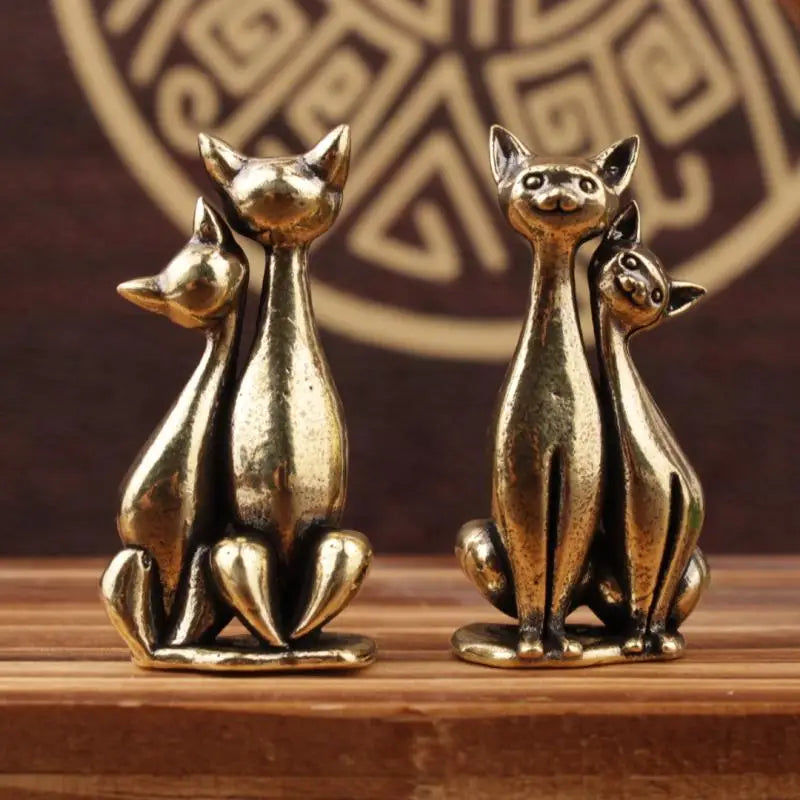 The Intertwined Loving Cats Brass Sculpture by KittyNook Cat Co. adds artful charm to any patterned backdrop.