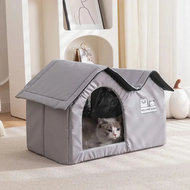 A gray cat relaxes in a KittyNook Cat Co. Portable Pet Cooling House in a cozy living room.