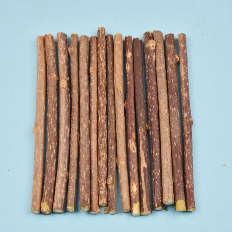 Fifteen KittyNook Cat Co. Natural Silvervine Chew Toys are lined up on blue, perfect for cat enrichment.