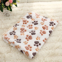 Thumbnail for The SnugglePaws Luxe Fleece Pet Blanket by KittyNook Cat Co. rests folded on a fluffy cream-colored rug.