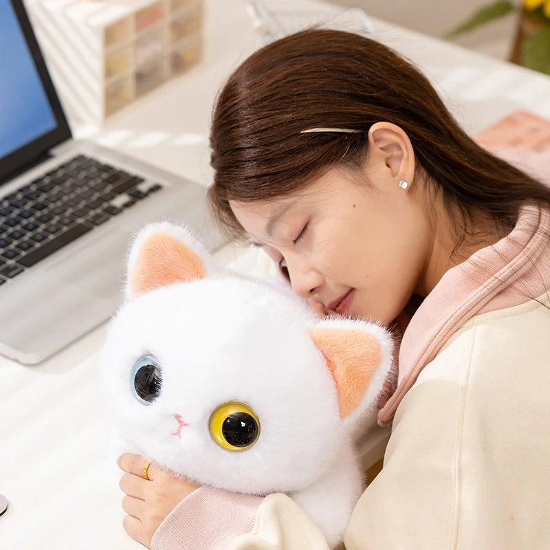 A woman naps with the KittyNook Cat Co. Cute Big Eyes Kitten Plush Pillow—a cozy cat lover gift for workdays.