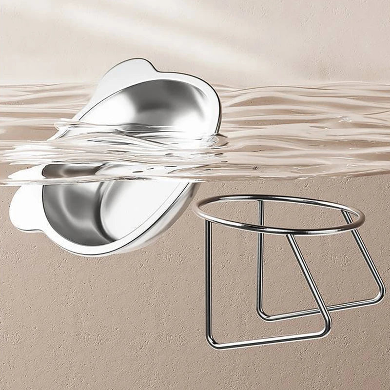 KittyNook Cat Co.'s Ergonomic Tilted Stainless Steel Cat Bowl and stand sit partly in clear water on a beige background.